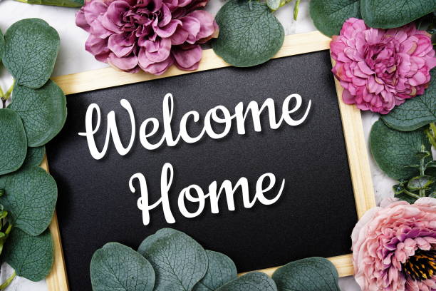 Welcome Home text on blackboard and eucalyptus leaves decoration on marble background
