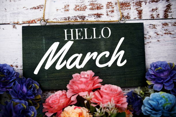 istock Hello March typography text decorate with flower on wooden background 1372691692