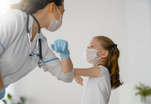 istock Doctor and child wearing facemasks 1372693267