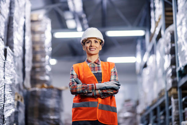 istock A happy warehouse worker standing with arms crossed. 1372694957