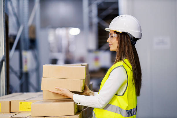 istock A female storage worker taking boxes for shipping. 1372695630