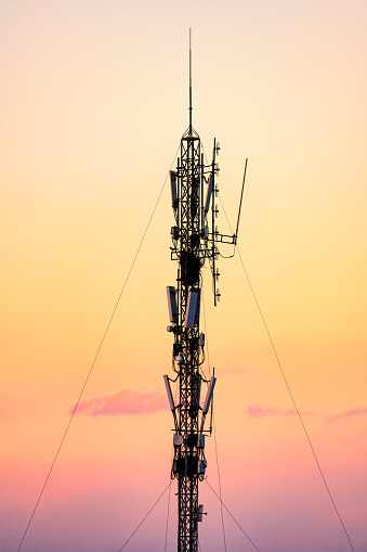5G Sunset Cell Tower: Cellular communications tower for mobile phone and video data transmission