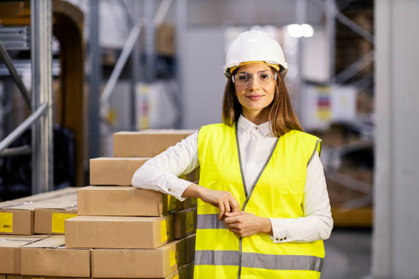 istock A warehouse supervisor leaning on boxes ready for shipping and smiling at the camera. 1372696149