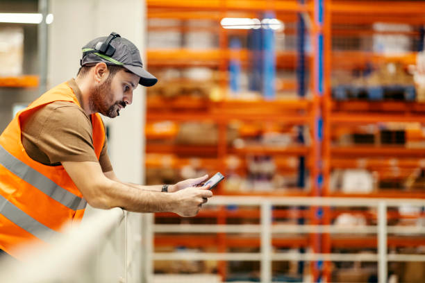 istock A boss with voice picking headset and tablet navigate delivery at warehouse. 1372696296