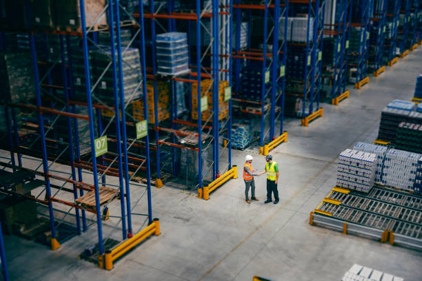 istock A businessman introducing himself to his worker at storage. 1372696319