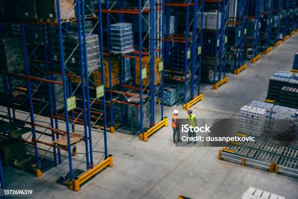 A Businessman Introducing Himself To His Worker At Storage Stock Photo - Download Image Now