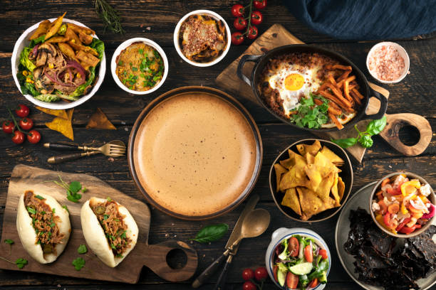istock Food Variety on table with empty plate 1372697005