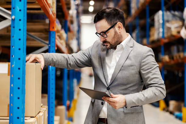 istock A warehouse inspector looking at box with tablet in hands and checking on order. 1372697686
