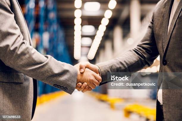 Close Up Of A Handshake Of Business Partners At Storage Stock Photo - Download Image Now