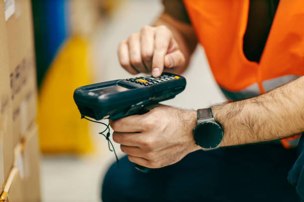 istock Close up of inspector scanning orders with qr and bar code scanner. 1372698567