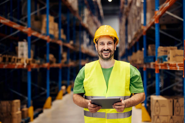 istock Portrait of a happy warehouse worker with tablet in hands checking on order. 1372698672