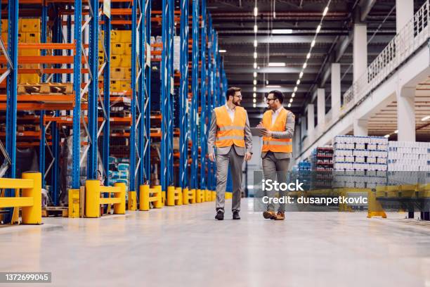 Storage Owner With Tablet In Hands Showing Around Storage To His Partner Stock Photo - Download Image Now