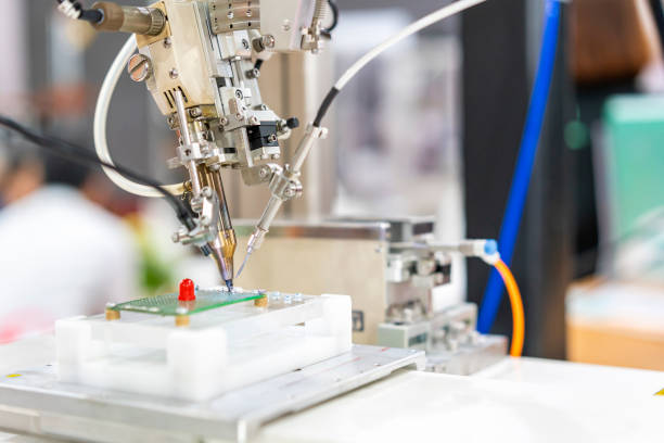 istock High technology automatic robot for pcb (print circuit board) assembly machine during soldering or welding part or component 1372699216
