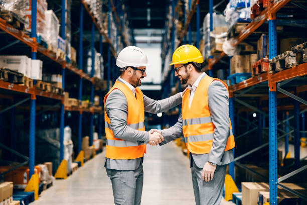 Two businessmen shaking hands and conclude an agreement at storage. stock photo