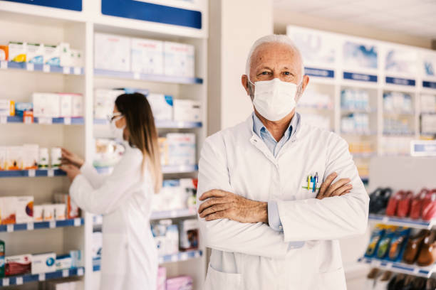 istock Senior pharmacist standing at pharmacy ready to help. 1372702191