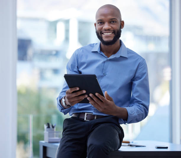 istock Shot of a young businessman using a digital tablet in an office at work 1372703071