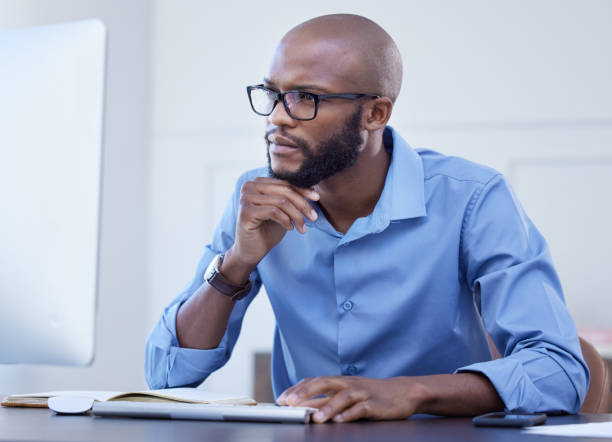 istock Shot of a young businessman using a computer at work 1372703461