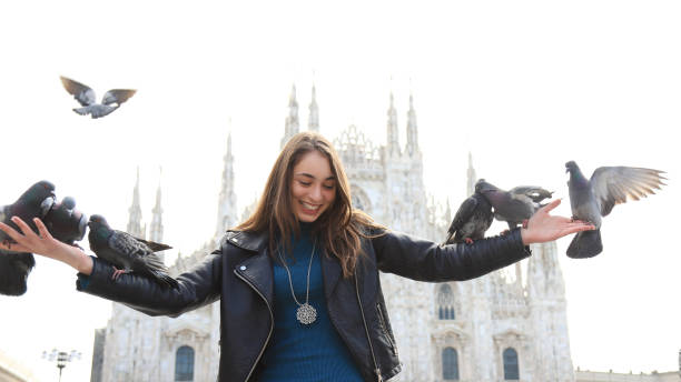 istock Woman playing with Pigeons 1372703505