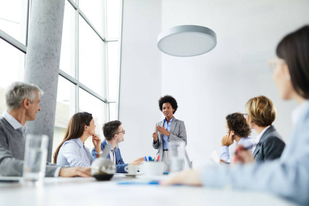 istock Black CEO giving a speech to her colleagues in the office. 1372709655