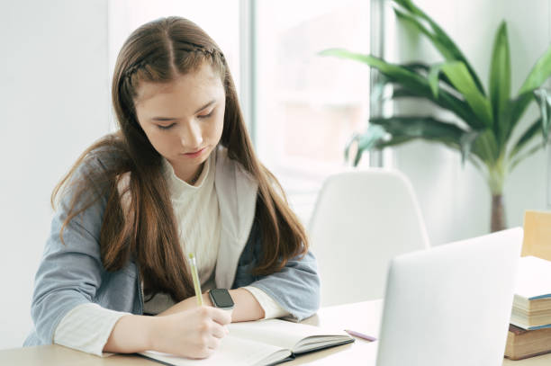 istock Girl learning online class with laptop computer at home 1372710851