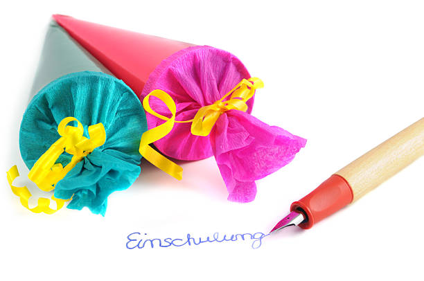 two Conical bags of sweets pen with German word Einschulung two Conical bag of sweets and pen with German word Einschulung zuckertüte stock pictures, royalty-free photos & images