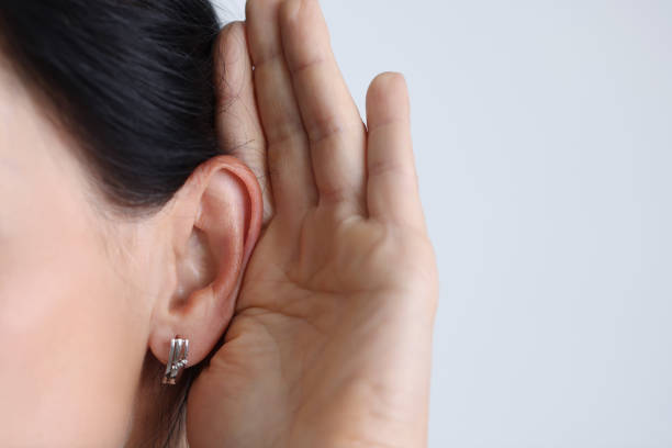 istock Woman held hand to ear and listened attentively. 1372714749