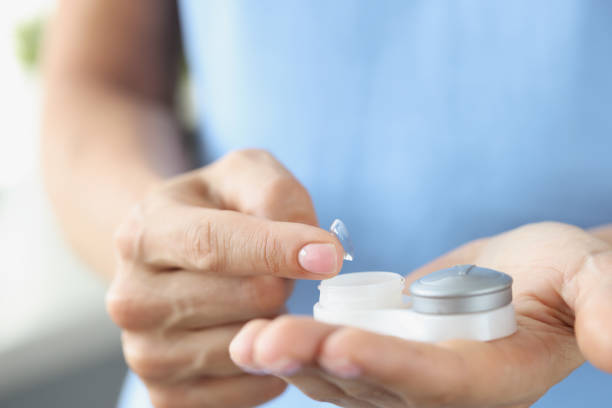 istock Soft contact lens with container in female hands closeup 1372714765