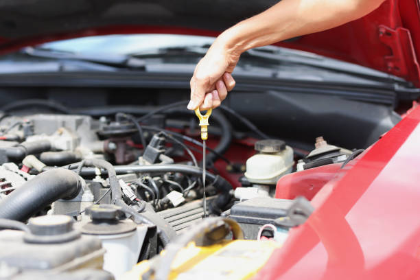istock Dipstick for checking oil level in car engine closeup 1372714773