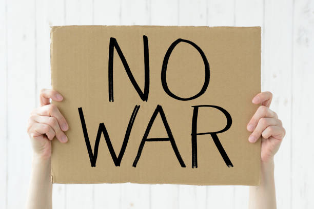 Cardboard with "NO WAR" message and human's hands Cardboard with "NO WAR" message and human's hands peace demonstration stock pictures, royalty-free photos & images
