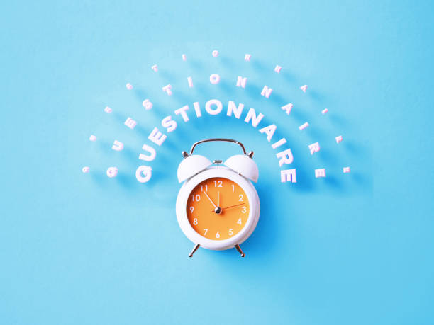 istock Questionnaire Message Sitting Above White Alarm Clock On Blue Background 1372716491