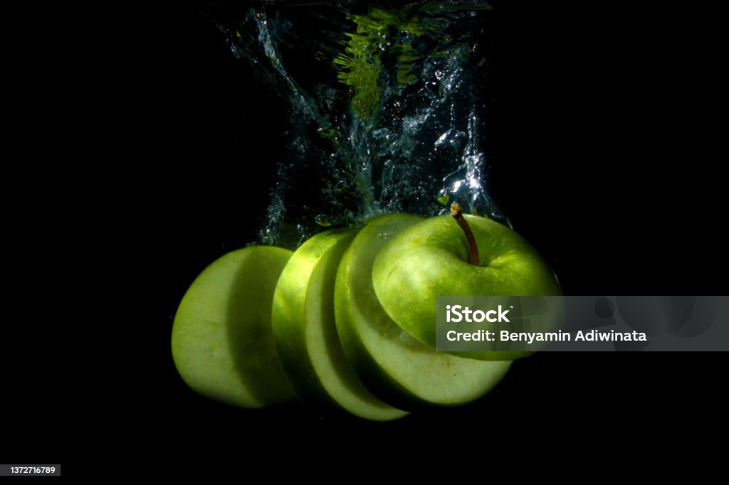 Slice of green apple in the water green apple in the water Apple - Fruit Stock Photo