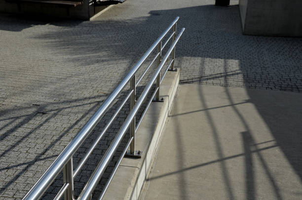 istock railing with two handrails. made of galvanized steel prisms. the lower railing is a protection against wheelchairs. ramp for the immobile in the housing estate, stainless steel, staircase, ramp 1372719584