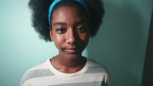Portrait of afro girl looking at camera, Studio shot