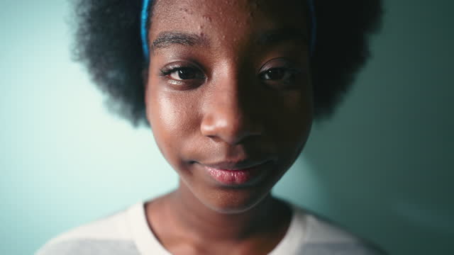 Portrait of afro girl looking at camera, Studio shot