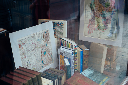 Display of books and maps taken through a window