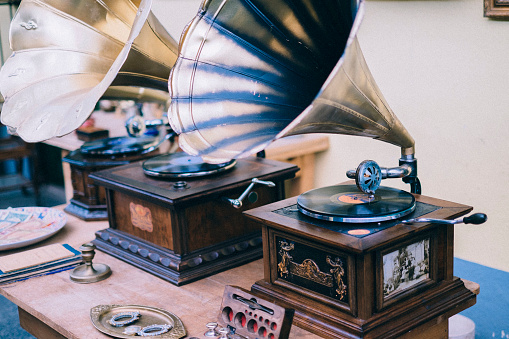 Vintage gramophone players for sale at a flea market