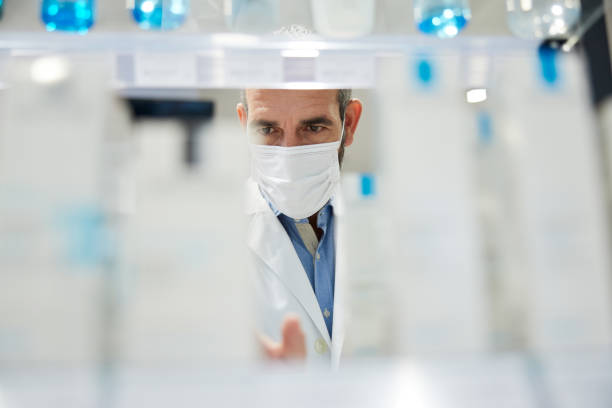 A healthcare worker viewed behind merchandise on a shelf.