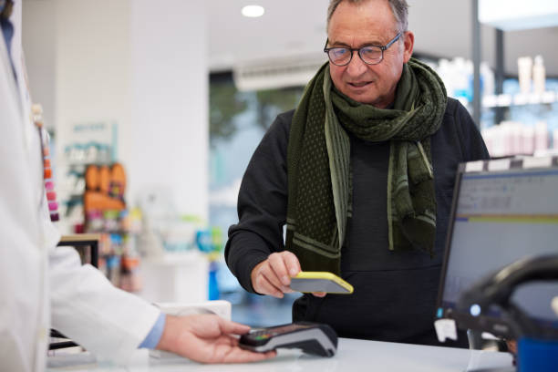 istock A senior customer pays with a smartphone. 1372727070