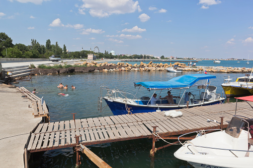 Evpatoria, Crimea, Russia - July 19, 2021: Parking of pleasure boats near the Evpatoria sea port, Crimea