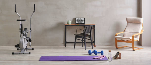 istock Sportive and training room style with purple mat dumbbell, computer background. 1372728929