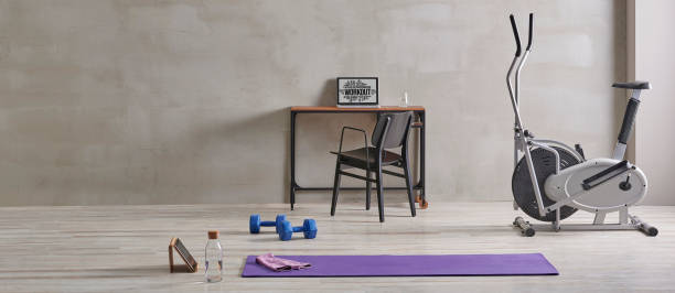 istock Sportive and training room style with purple mat dumbbell, computer background. 1372728958