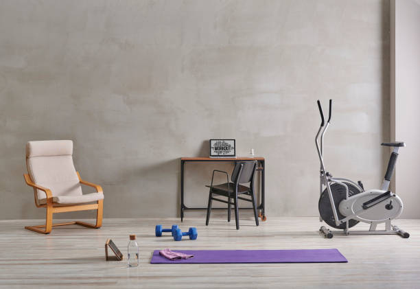 istock Sportive and training room style with purple mat dumbbell, computer background. 1372728997