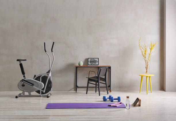 istock Sportive and training room style with purple mat dumbbell, computer background. 1372728999