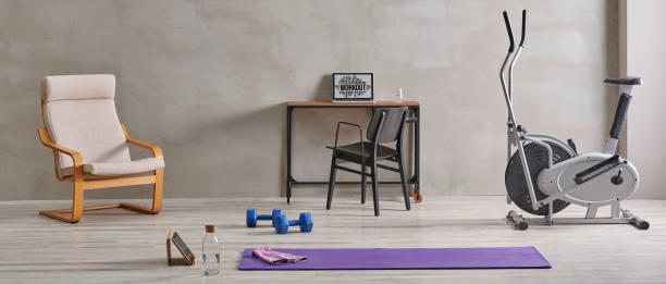 istock Sportive and training room style with purple mat dumbbell, computer background. 1372729003