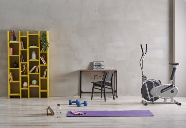 istock Sportive and training room style with purple mat dumbbell, computer background. 1372729009