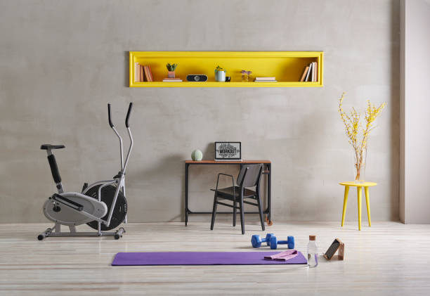 istock Sportive and training room style with purple mat dumbbell, computer background.Yellow bookshelf shelf book flower i pad laptop computer 1372729104