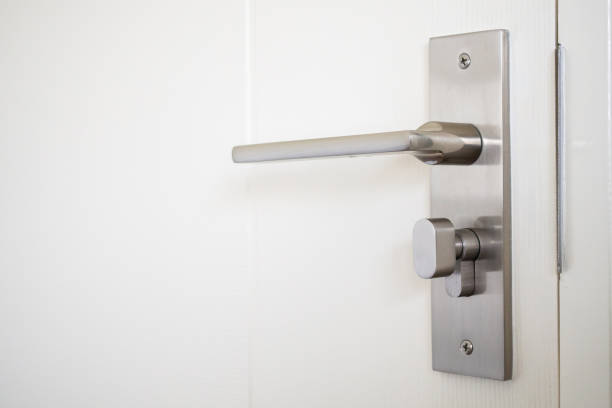 istock Modern door handle with on white door 1372730709