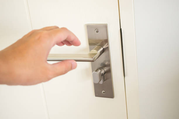 istock Man hand holding door handle close up 1372730711