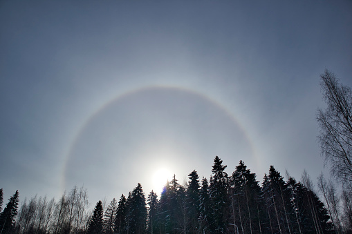 sun halo with circular rainbow in winter sky