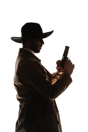 Body shot of an attractive male model posing with a weapon against white background